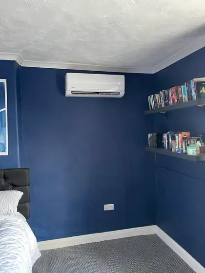 Air conditioning in a navy-painted home office with bookshelves