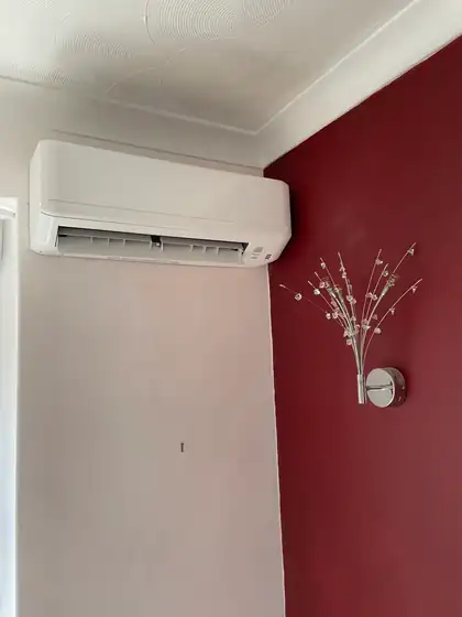 Split air conditioner on a red feature wall