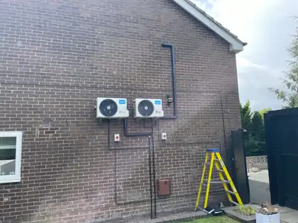 Two outdoor units side by side serving a multi-room air conditioning installation